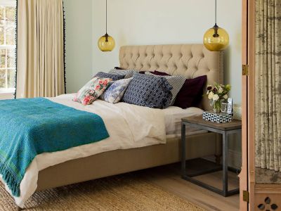 amber glass pendant lights hang in bedroom