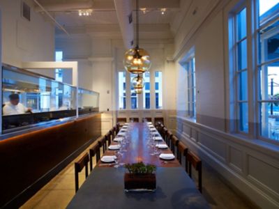 large glass pendant lights above private dining room table