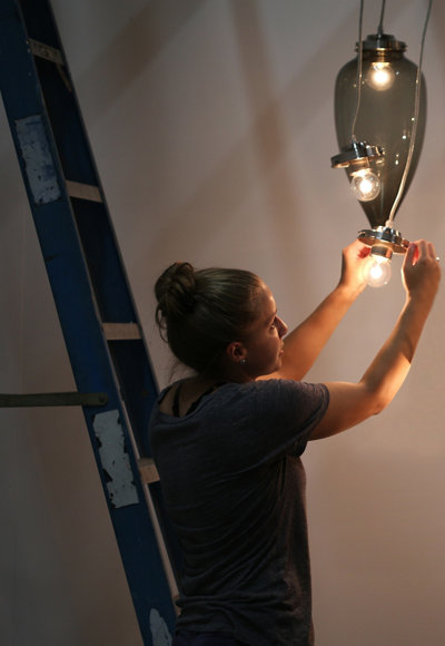 Niche marketing team member Britney installing lights for a photo shoot