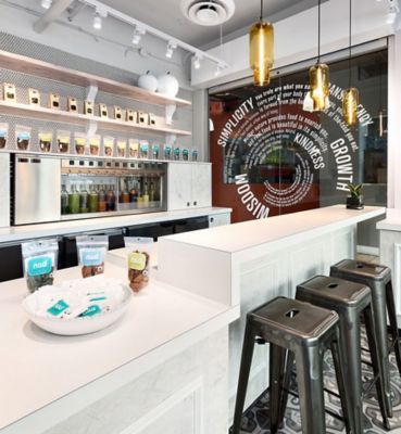 amber glass pendant lighting above counter in juice bar