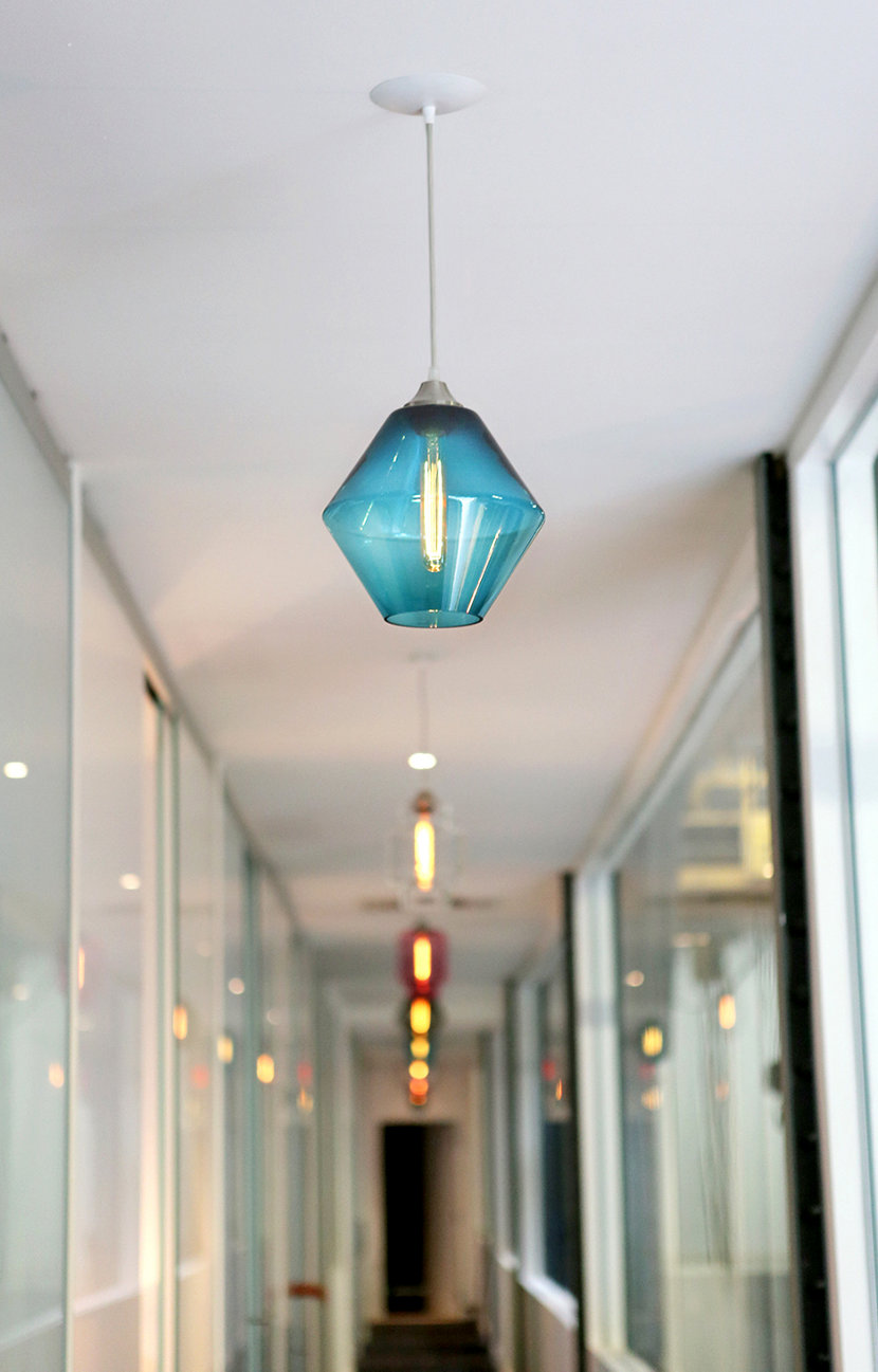 modern glass lighting in office hallway